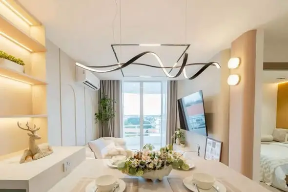 Modern living room with elegant lighting and open view, featuring stylish decor and cozy ambiance.