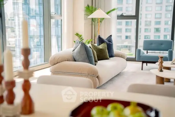 Luxurious modern living room with plush sofa and city view, perfect for urban living.