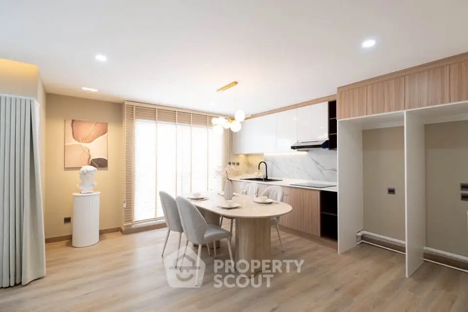 Modern open-plan kitchen and dining area with stylish decor and natural light.