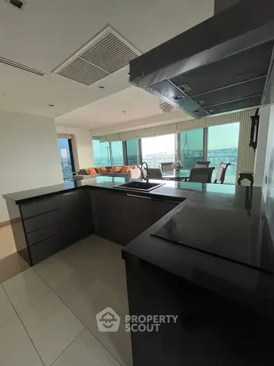 Spacious modern kitchen with open layout and stunning view in luxury apartment.