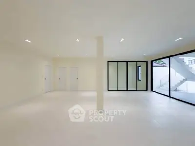 Spacious modern living room with large windows and minimalist design
