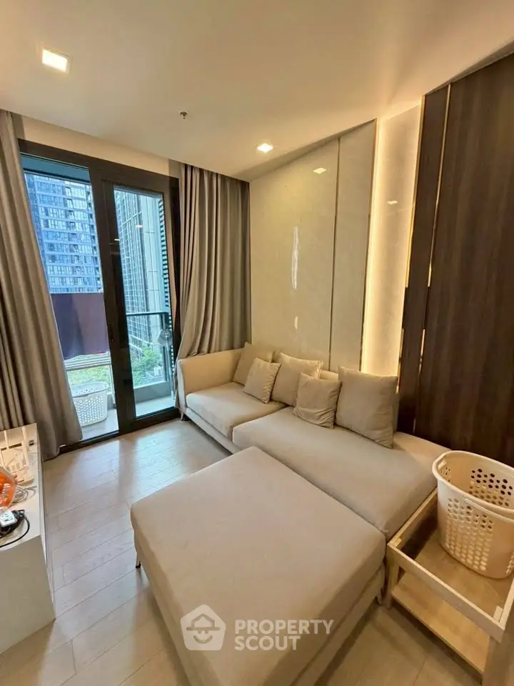 Modern living room with cozy seating and balcony view in urban apartment