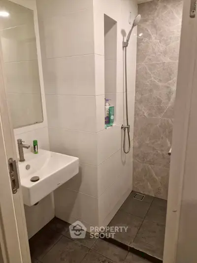 Modern bathroom with sleek shower and minimalist sink design