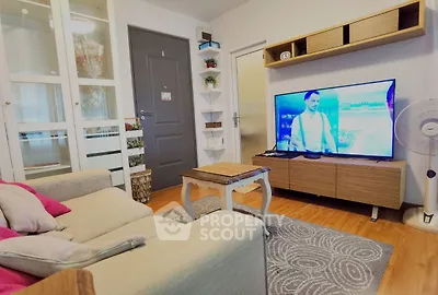 Cozy living room with modern decor and large TV, perfect for relaxation.