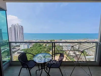 Stunning balcony view of ocean and cityscape from high-rise apartment
