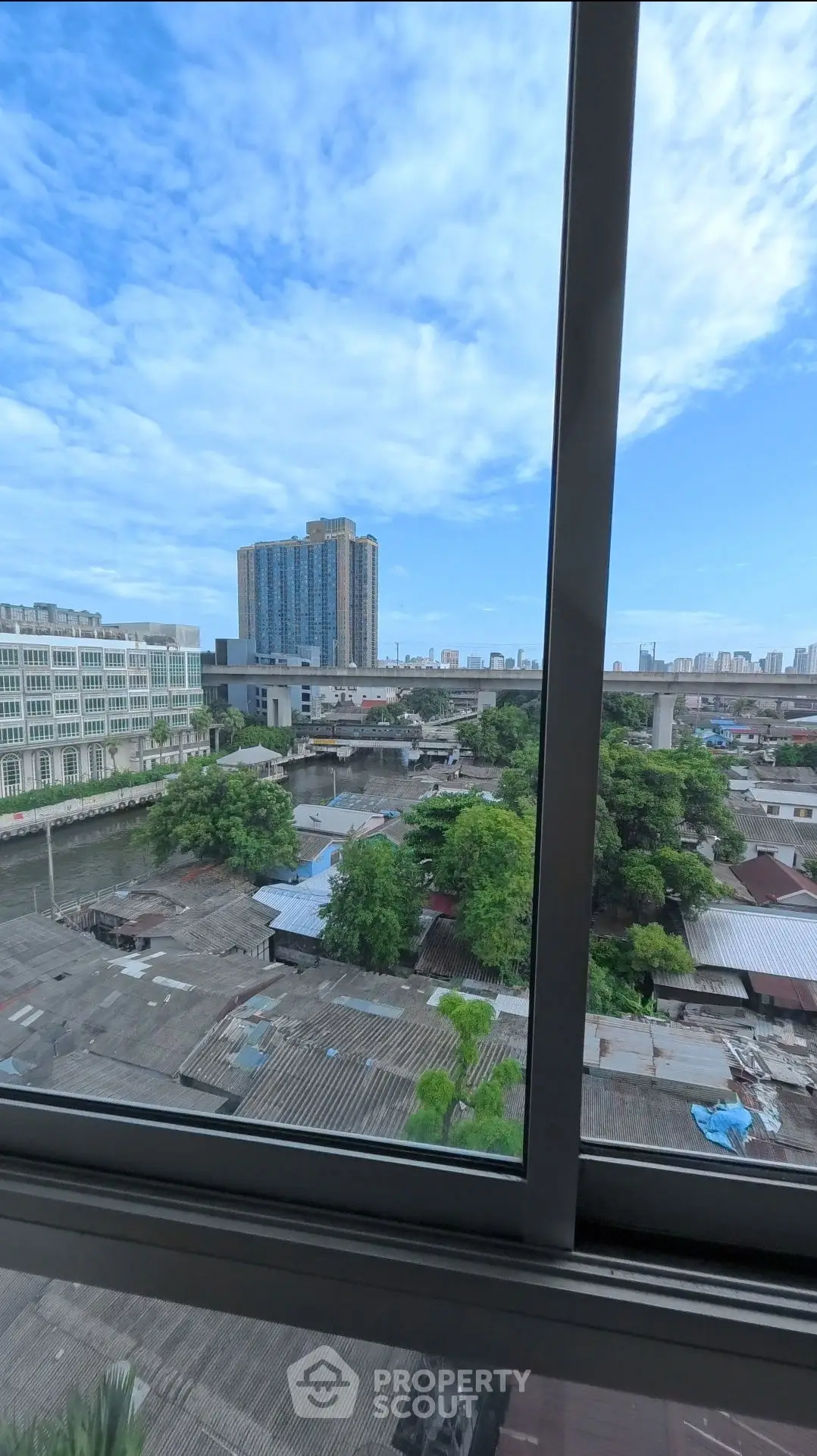 Stunning cityscape view from high-rise window with clear blue sky