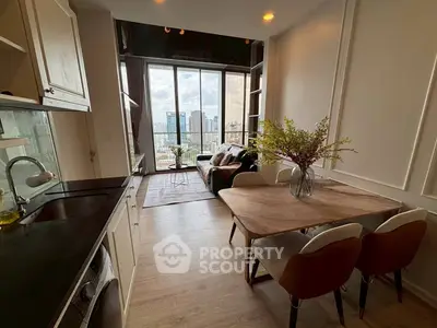Modern open-plan kitchen and living room with stunning city view from large windows.