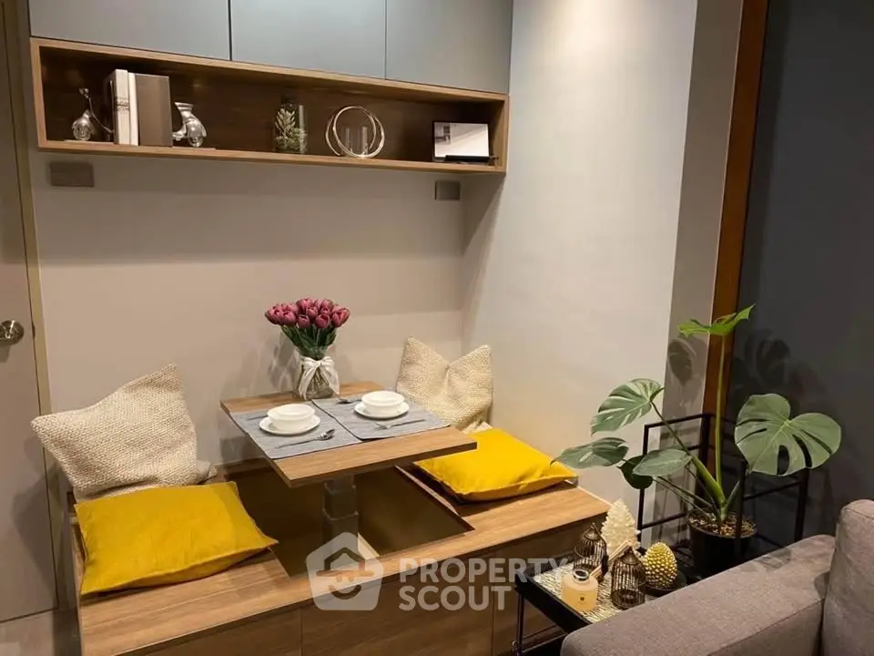 Cozy dining nook with modern decor and stylish shelving in a compact living space.