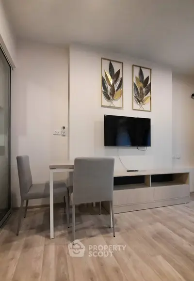 Modern living room with stylish decor and mounted TV, perfect for relaxation and entertainment.