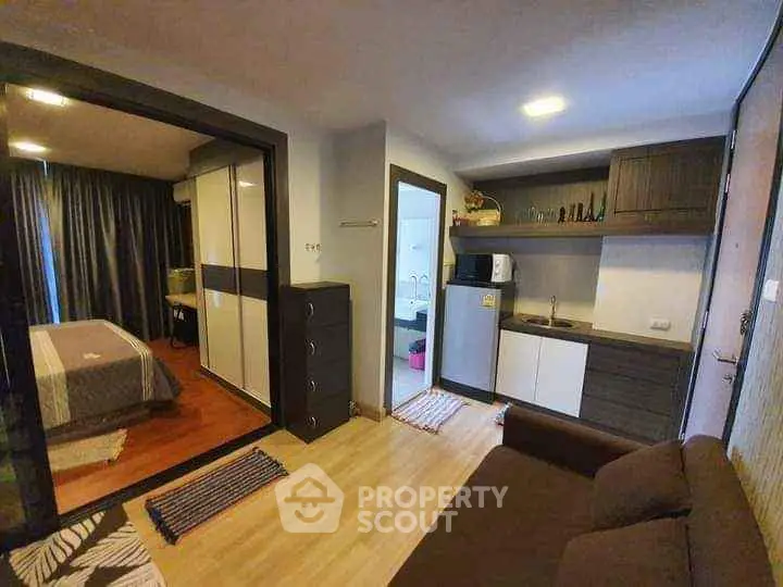 Cozy studio apartment with modern kitchen and bedroom view