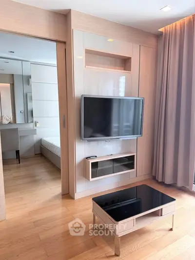 Modern living room with sleek TV setup and elegant wooden flooring