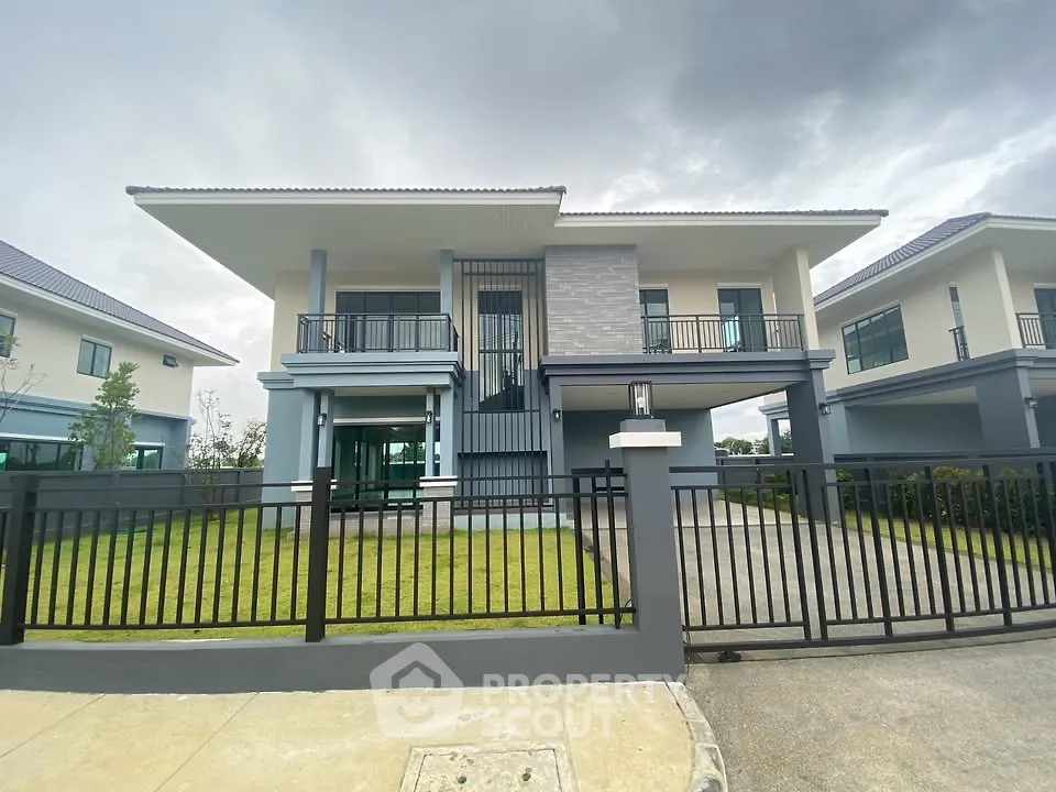 Modern two-story house with sleek design and spacious front yard