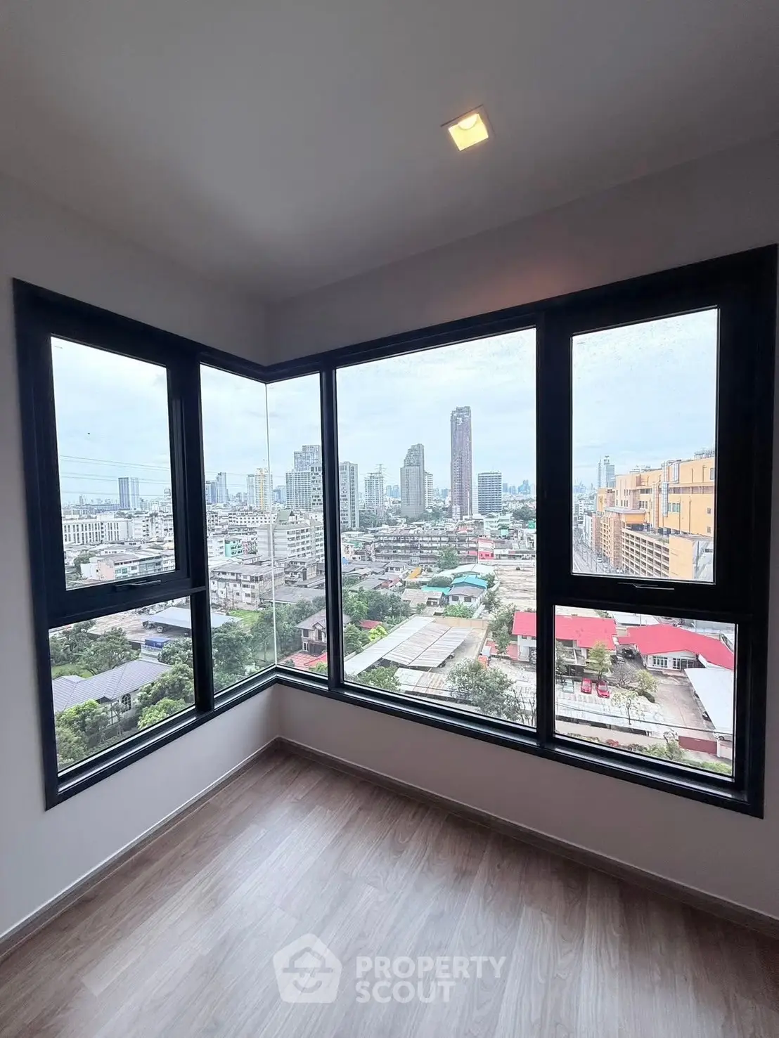 Stunning corner unit with panoramic city views from floor-to-ceiling windows.