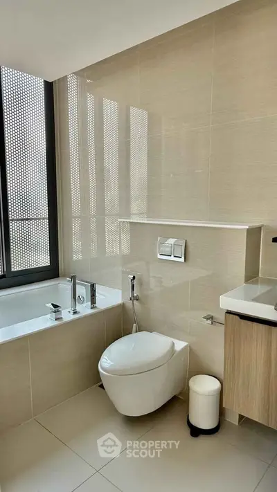 Modern bathroom with sleek fixtures and large window for natural light.