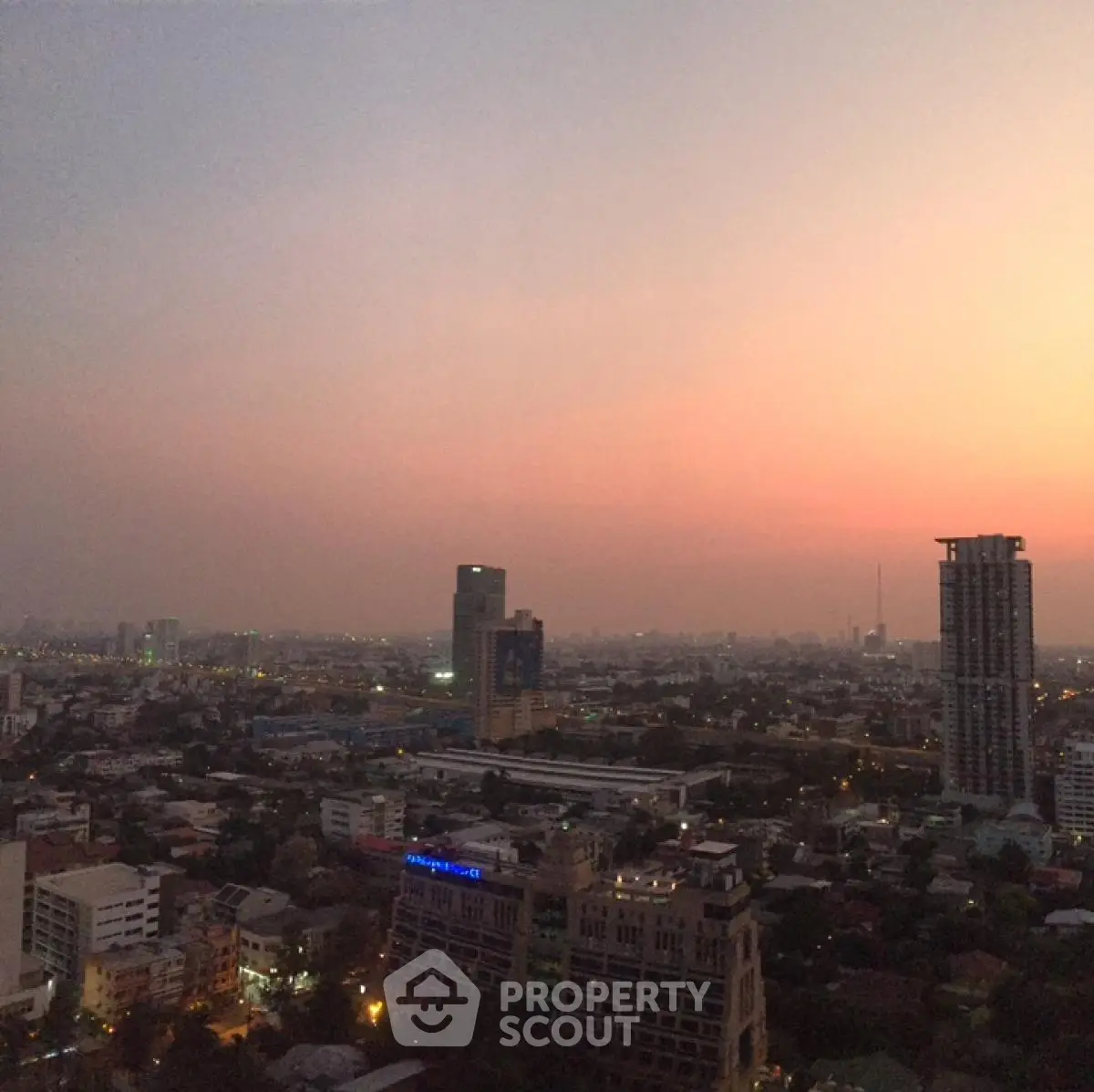 Stunning cityscape view at sunset showcasing urban skyline and high-rise buildings.