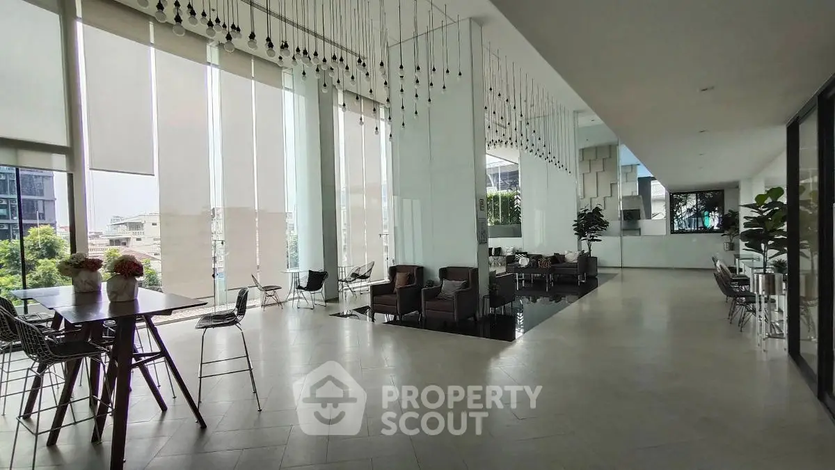 Spacious modern living area with floor-to-ceiling windows and stylish decor
