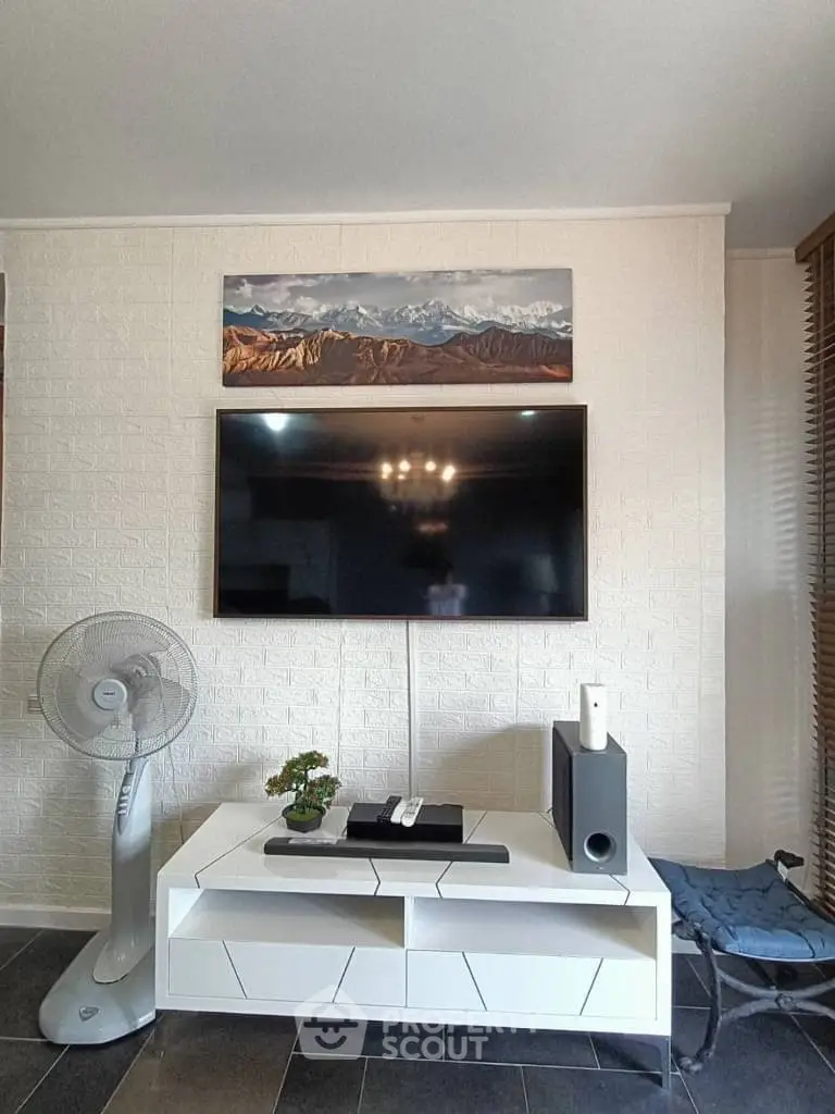 Modern living room with wall-mounted TV and stylish decor