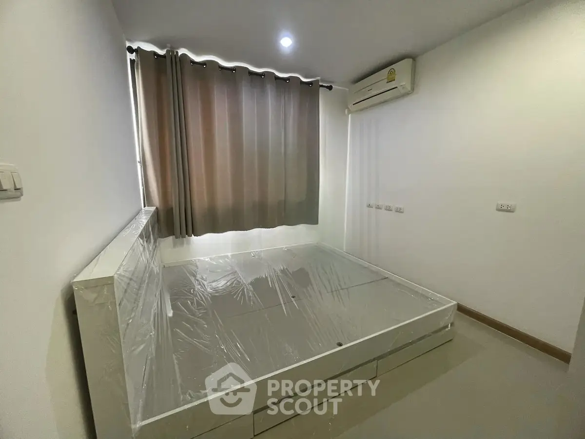 Modern bedroom with minimalist design and air conditioning in a stylish apartment.