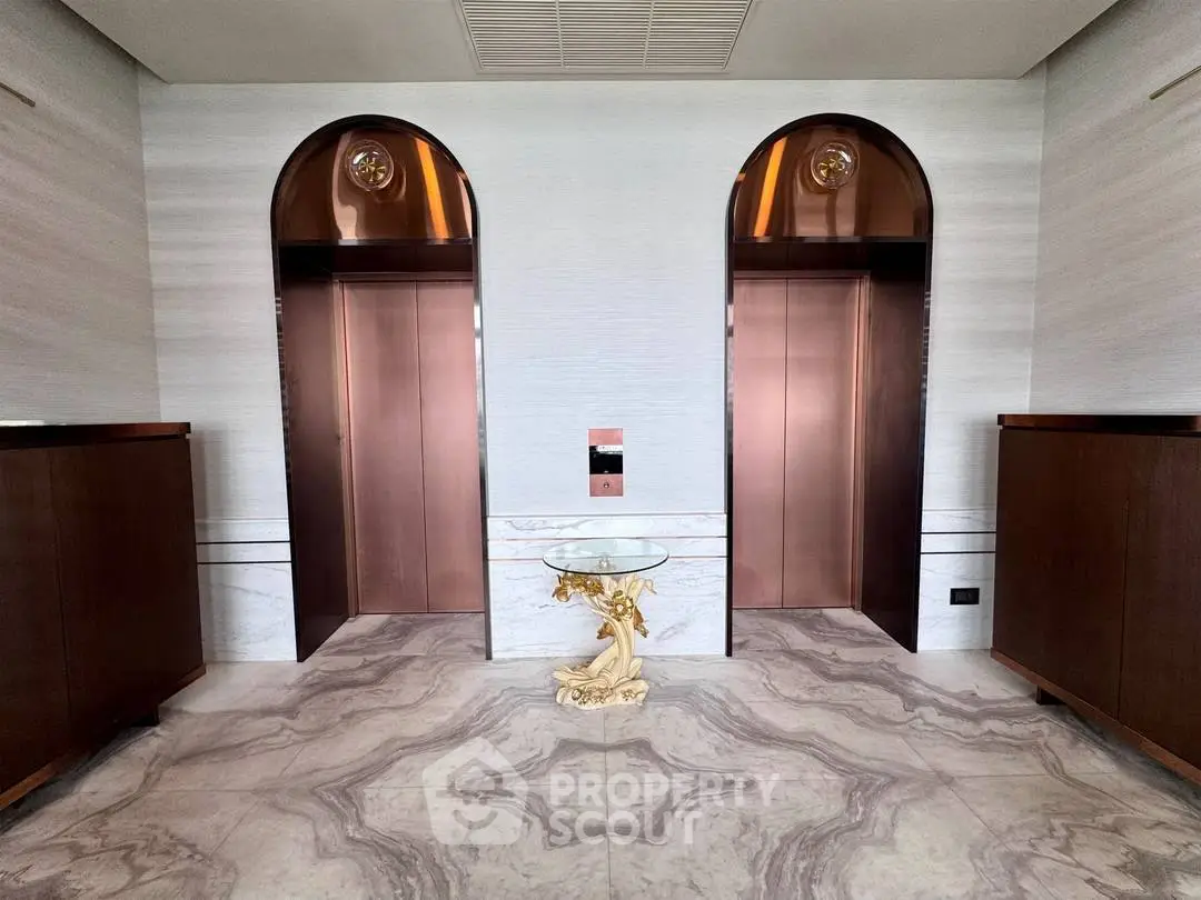 Luxurious modern elevator lobby with marble flooring and elegant decor.
