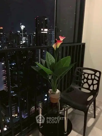 Chic urban balcony with stunning city skyline view at night, perfect for relaxation.