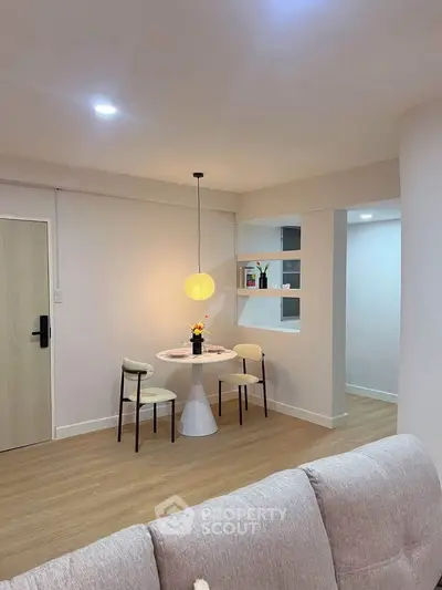 Cozy modern living area with stylish dining nook and elegant lighting