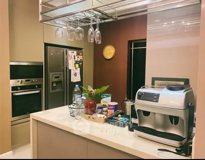 Modern kitchen with stainless steel appliances and coffee machine