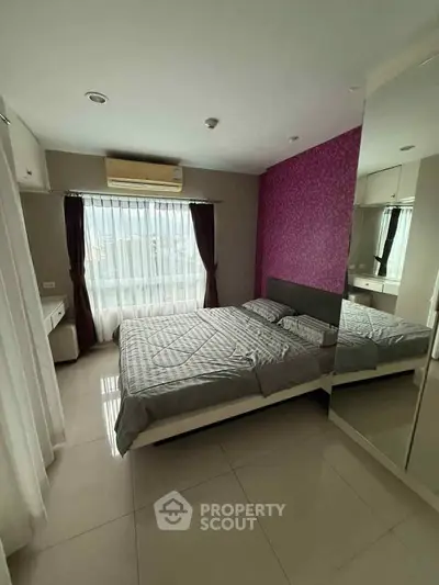 Modern bedroom with stylish decor and large window for natural light