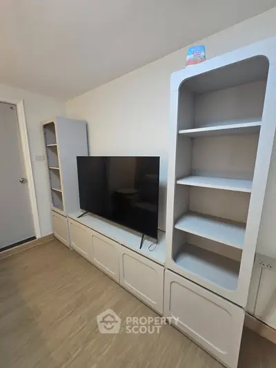 Modern living room with sleek TV unit and stylish shelving