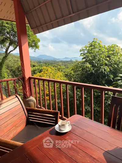 Charming balcony with stunning mountain and forest views, perfect for relaxation and enjoying a morning coffee.
