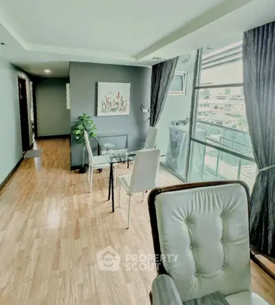 Spacious living room with modern decor and large windows offering a stunning view.