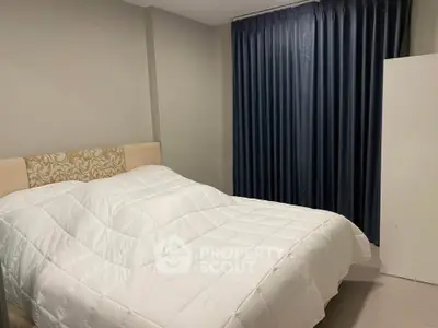Cozy bedroom with elegant decor and plush bedding in modern apartment.
