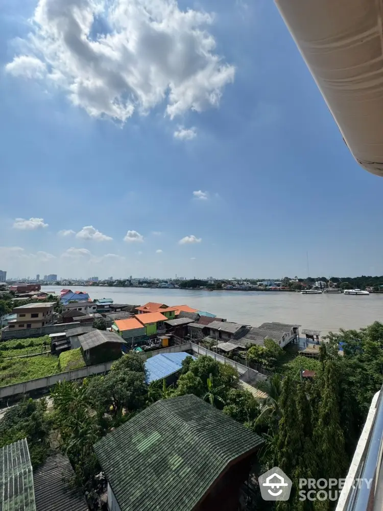 Stunning river view from high-rise balcony with clear blue skies