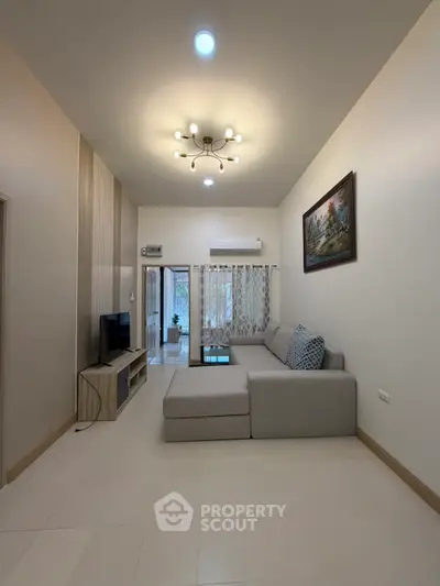 Modern living room with stylish chandelier and cozy sectional sofa
