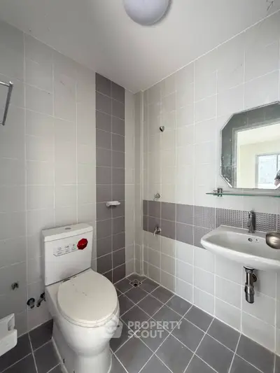 Modern bathroom with sleek gray tiles and minimalist fixtures