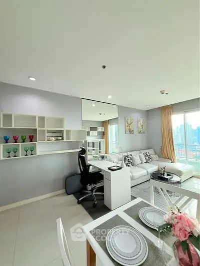 Modern living room with city view, stylish decor, and open layout in a high-rise apartment.