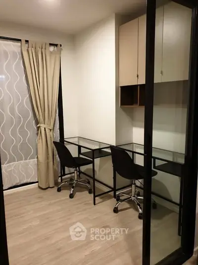 Modern study room with glass desks and chairs, ideal for productivity.