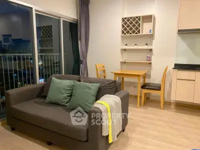 Modern living room with balcony view, cozy sofa, and dining area in stylish apartment.