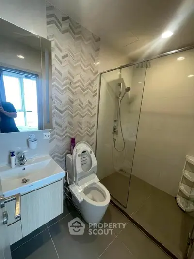 Modern bathroom with glass shower and sleek fixtures