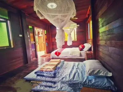 Charming rustic bedroom with wooden walls and cozy bedding, featuring a romantic canopy and vibrant decor.