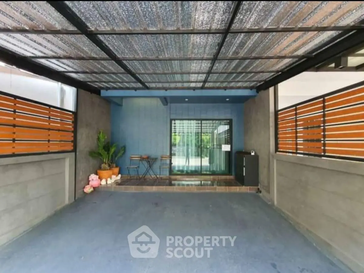 Spacious covered parking area with modern design and seating