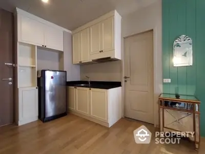 Charming compact kitchen with modern appliances and elegant cabinetry