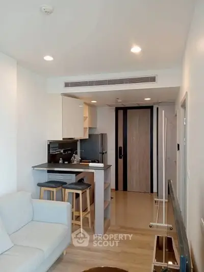 Modern apartment interior with cozy living area and compact kitchen