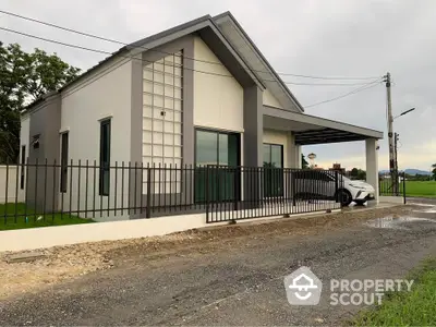 Modern single-story house with sleek design and spacious driveway in a serene neighborhood.