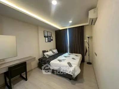 Modern bedroom with stylish decor and natural lighting, featuring a cozy bed and sleek furnishings.