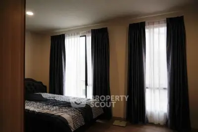 Cozy bedroom with elegant curtains and soft lighting