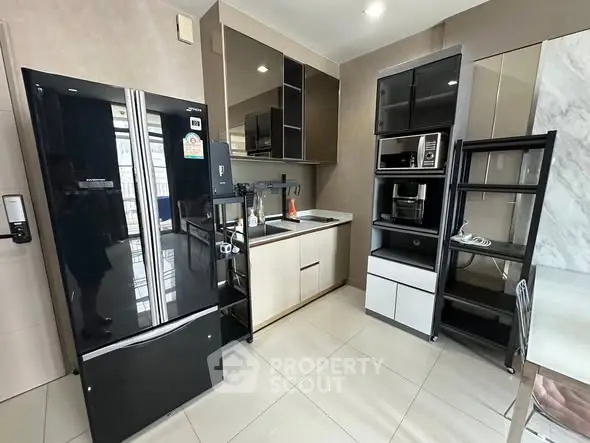 Modern kitchen with sleek black appliances and glossy cabinets