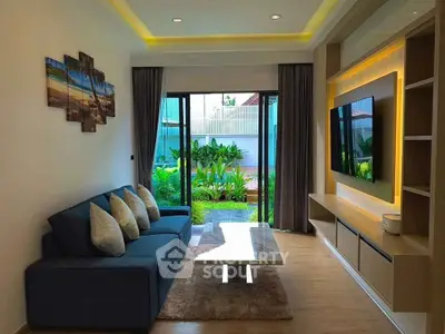 Modern living room with garden view, sleek furniture, and ambient lighting.