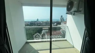 Stunning balcony view overlooking cityscape and ocean, perfect for relaxation.