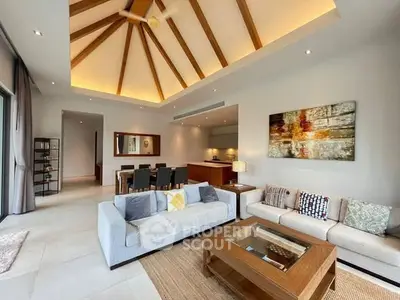 Luxurious living room with high ceiling and modern decor in a spacious open-plan layout.