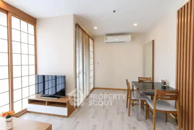 Modern living room with natural light, wooden accents, and sleek furniture in a stylish apartment.